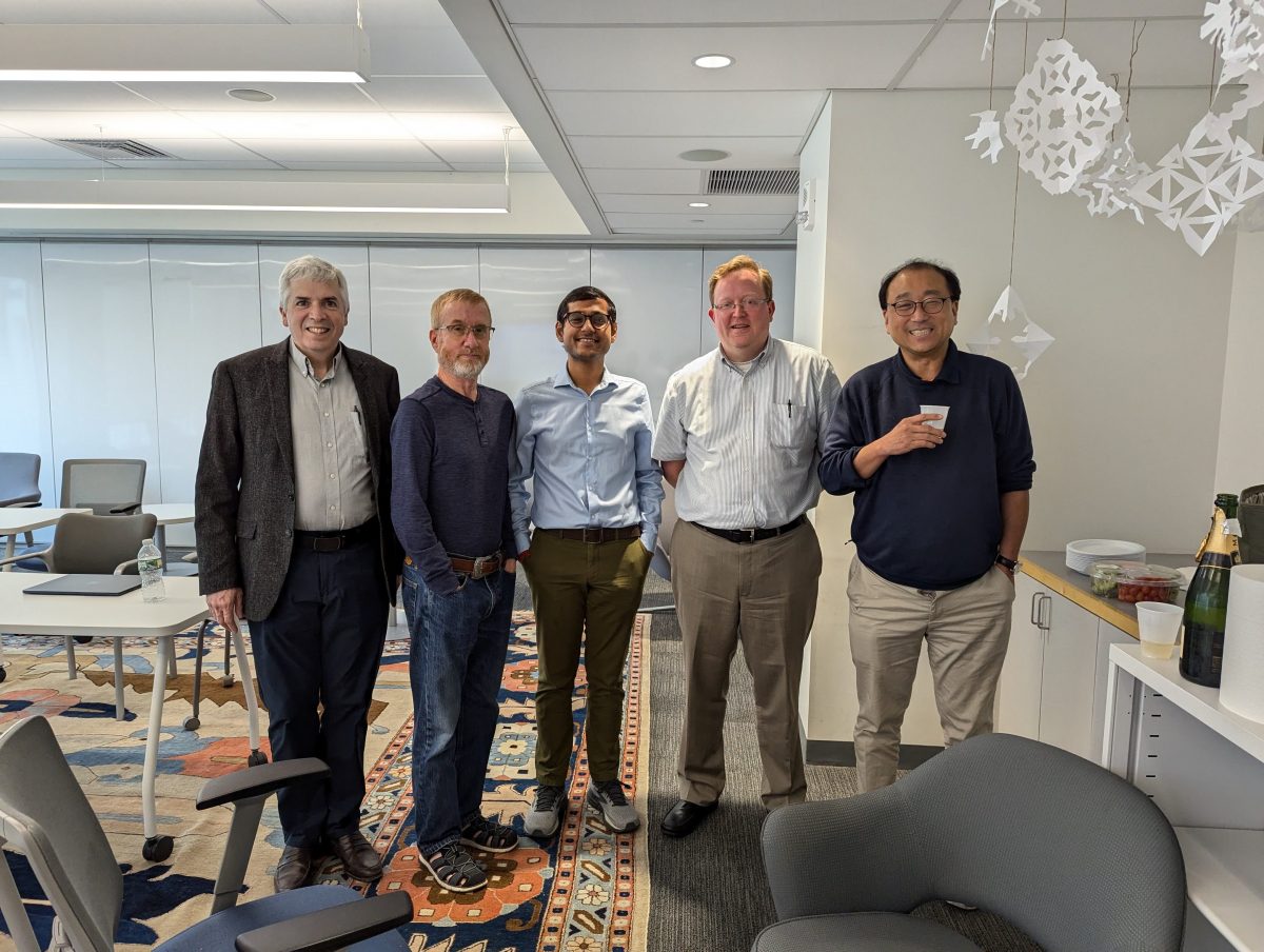 Provakar celebrating with the committee after successfully defending his thesis